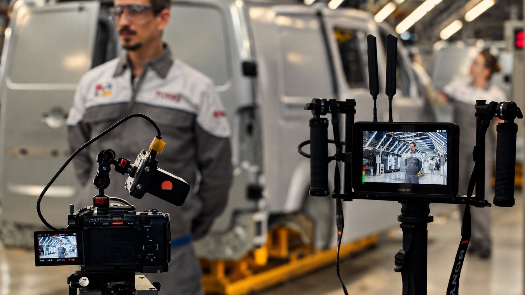Two-camera interview setup on a factory floor
