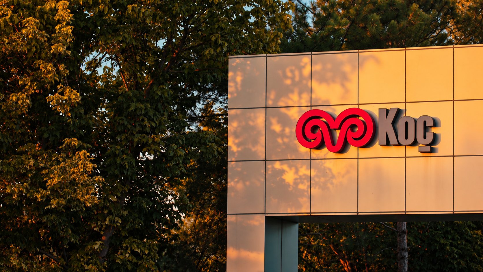 Koç sign on a building at sunset